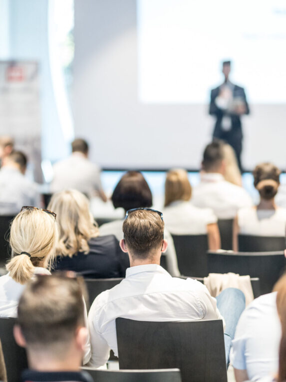 Professional conference with an attentive audience and on-stage speaker - ideal for corporate events, seminars, training courses or workshops.