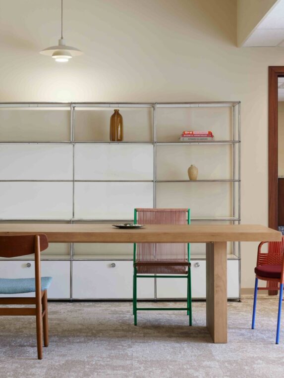 Design meeting room with colorful furniture and minimalist bookcase - an inspiring, elegant workspace, ideal for creative meetings or business appointments.