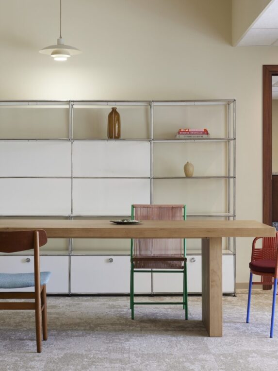 Modern meeting room in the Hotel des Victoires in Cannes-la-bocca in the South of France. Wooden and colorful urban furniture, with wall shelves and gray carpeting.