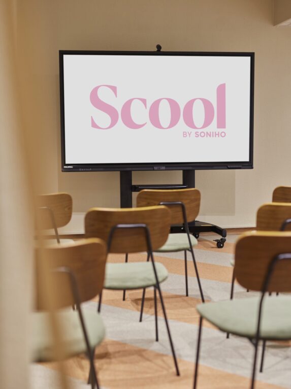 Shot between wooden chairs in a Scool meeting room at the Hotel des Victoires in Cannes-la-Bocca.